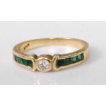 An 18ct gold, emerald and diamond half hoop ring, arranged as an illusion set brilliant cut