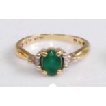 An 18ct gold, emerald and diamond dress ring, the four claw set oval cut emerald weighing approx 0.7