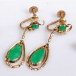 A pair of early 20th century yellow metal and green jade set ear clips, each with pear shaped drops,