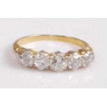 A yellow metal diamond five-stone ring, the slightly graduated old round cut diamonds in a carved