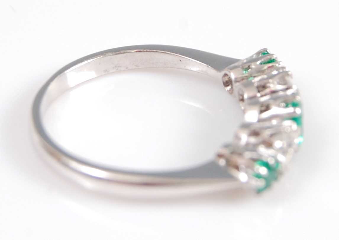 A white metal, emerald and diamond five stone half hoop eternity ring, featuring three graduated - Image 5 of 6