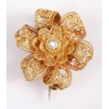 An early Victorian yellow metal mourning brooch, in the form of a filigree six petal flower with