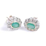 A pair of 9ct yellow and white gold, emerald and diamond oval cluster earrings, each featuring a