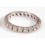 A white metal diamond full hoop eternity ring, comprising 22 round brilliant cut diamonds in claw