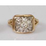 An 18ct gold diamond flowerhead cluster ring, arranged as a centre old brilliant cut diamond in a