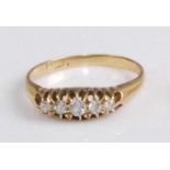 An 18ct gold diamond five-stone ring, the graduated old cut diamonds in a line setting, the centre