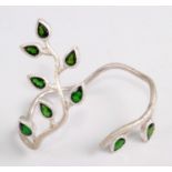 A contemporary silver and diopside bangle, naturalistically worked as leaves issuing from a single