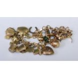 A 9ct gold charm bracelet, containing numerous novelty charms, principally 9ct, 34.5g
