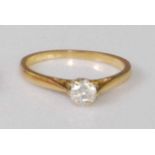 A contemporary 18ct gold diamond solitaire ring, the claw set brilliant weighing approx 0.33 carats,