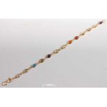 A yellow metal multi-stone bracelet, featuring amethyst, citrine, topaz, garnet, peridot, blue topaz