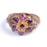 A late 19th century garnet ring, comprising a flower design set with one round and six oval