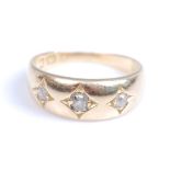 An 18ct yellow gold diamond Gypsy style ring, comprising three graduated old cushion cut diamonds in