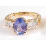 An 18ct yellow gold, tanzanite and diamond dress ring, the oval tanzanite measuring approx 8.85 x