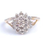 A yellow and white metal circular diamond cluster ring, featuring nineteen round brilliant cut