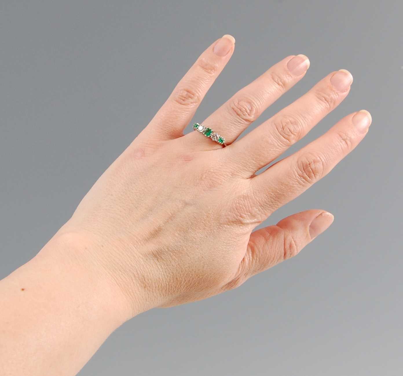 A white metal, emerald and diamond five stone half hoop eternity ring, featuring three graduated - Image 6 of 6