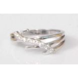 A contemporary 14ct white gold diamond set dress ring, the split shank surmounted with a row of