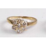 An 18ct gold diamond cluster ring, the seven claw set brilliants arranged in a flower head