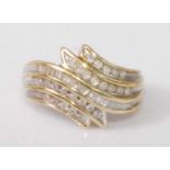 A contemporary 9ct gold diamond set dress ring, arranged as five tiered rows of channel set