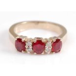 A yellow metal, ruby and diamond seven stone half hoop eternity ring, comprising three oval rubies