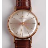 A Gents Jaegar LeCoultre 9ct gold manual wind wristwatch, having round silvered baton dial and