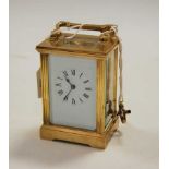 A lacquered brass cased carriage clock, having enamelled dial with Roman numerals, visible