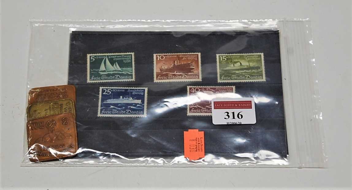 A collection of Deutschreich stamps; together with three Channel Islands tokens