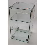 A three-tier glass display case, h.58cm