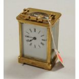 A lacquered brass cased carriage clock, having enamelled dial with Roman numerals, visible