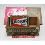 A Hudson's Soap enamel advertising sign (with losses), 18 x 25cm; together with a 'Drink Camp' tin