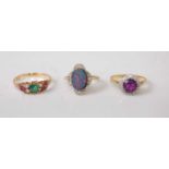 Three yellow metal rings, comprising an oval opal doublet and diamond cluster ring, the twelve