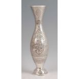An early 20th century Persian white metal vase, of tulip shape, having all-over foliate engraved