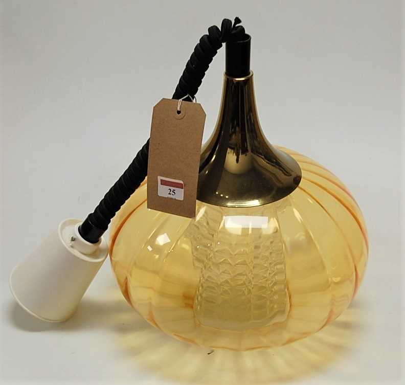 A 1960s amber glass onion shaped hanging pendant ceiling light, having a metal attachment, plastic