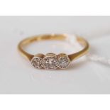 An 18ct gold diamond three-stone ring, the illusion set round cut diamonds weighing approx 0.3