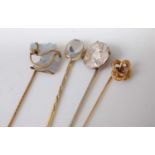 Four various stick pins, to include moonstone and old cut diamond horse head, and a Napoleon