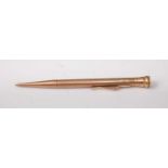 A 9ct engine turned gold propelling pencil, gross weight 13.7g, 11cm
