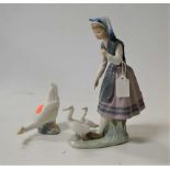 A Lladro porcelain figure group of a girl with ducks; together with a Nao porcelain duck (2)