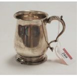 A George V silver christening mug, of bell shape, having a flying C-scroll handle, engraved with