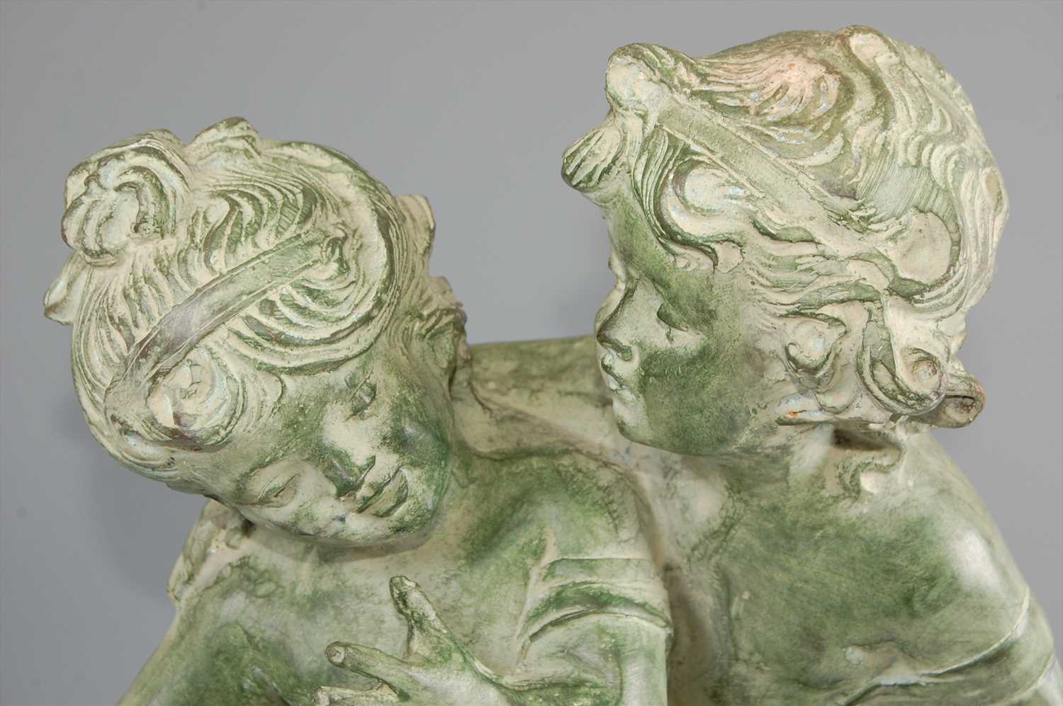 A large contemporary green patinated bronze model of a young boy and girl, each semi-nude, in - Image 2 of 4
