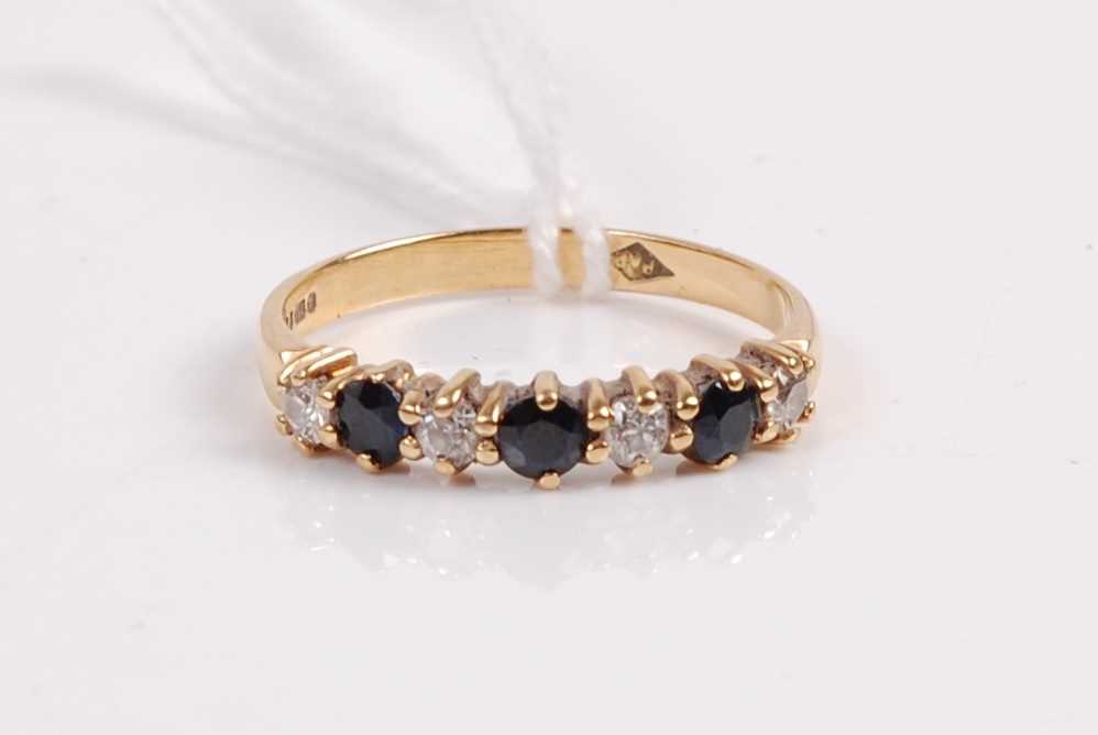 A contemporary 18ct gold, sapphire and diamond half hoop ring, total diamond weight estimated as