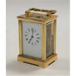 A lacquered brass cased carriage clock, having an enamelled dial with Roman numerals, visible