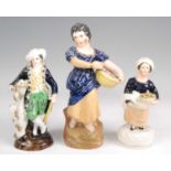 A Victorian Staffordshire figure of a lady, in standing pose and wearing blue dress with yellow