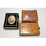 A late Victorian walnut and metal bound photograph album, the contents mainly being family