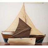 A scratch-built single masted model sailing boat, length 74cm; and one other smaller example (2)