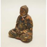 A cast iron polychrome painted and lacquered figure of a Buddha, in typical seated pose, h.13cm
