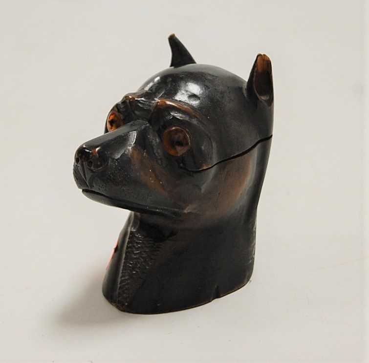 A late Victorian carved pine novelty table lighter in the form of a dogs head, having glass eyes and