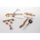Assorted principally circa 1900 yellow metal bar brooches and tie-pins, to include seed pearl set