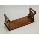 A Victorian walnut book trough, having pierced folding ends