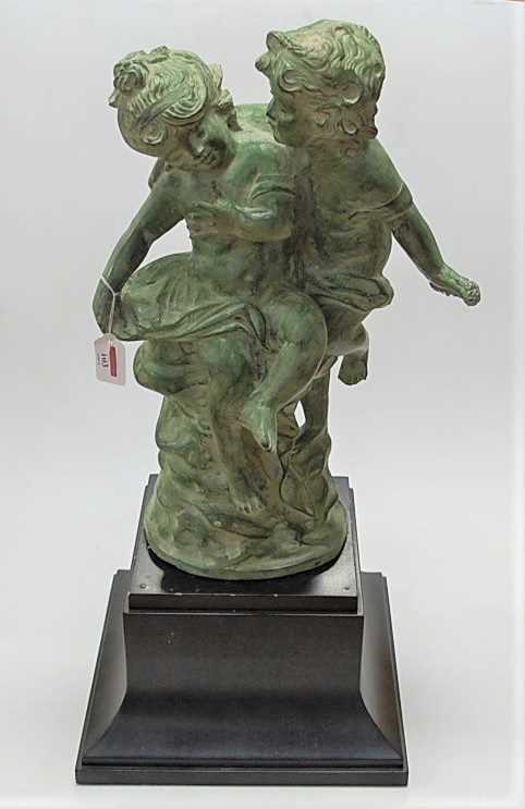 A large contemporary green patinated bronze model of a young boy and girl, each semi-nude, in