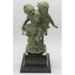 A large contemporary green patinated bronze model of a young boy and girl, each semi-nude, in