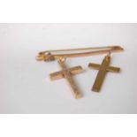 A 9ct gold and blue stone set safety pin bar brooch, 5cm; together with two 9ct gold cross pendants,